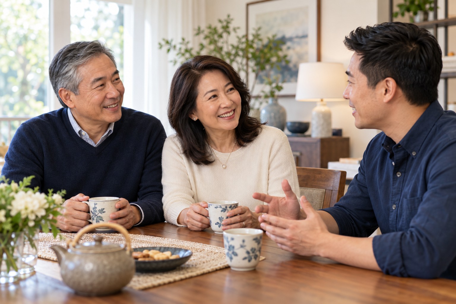 Parents and their adult son enjoying a conversation at home
